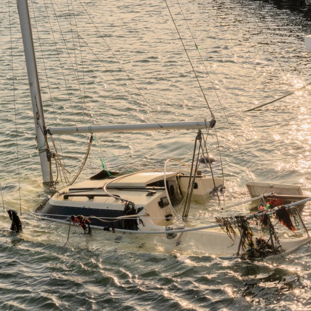 Sunken boat near shore as water incident evidence