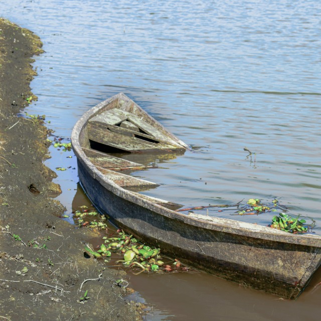 Small rowboat on waterfront for drowning liability and insurance review