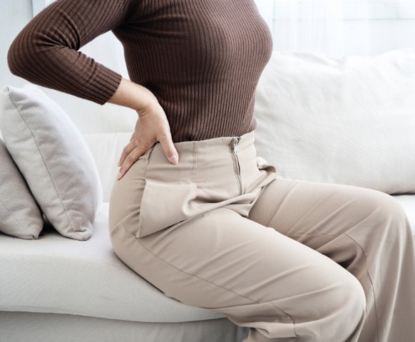 Woman experiencing lower back pain after a spinal injury