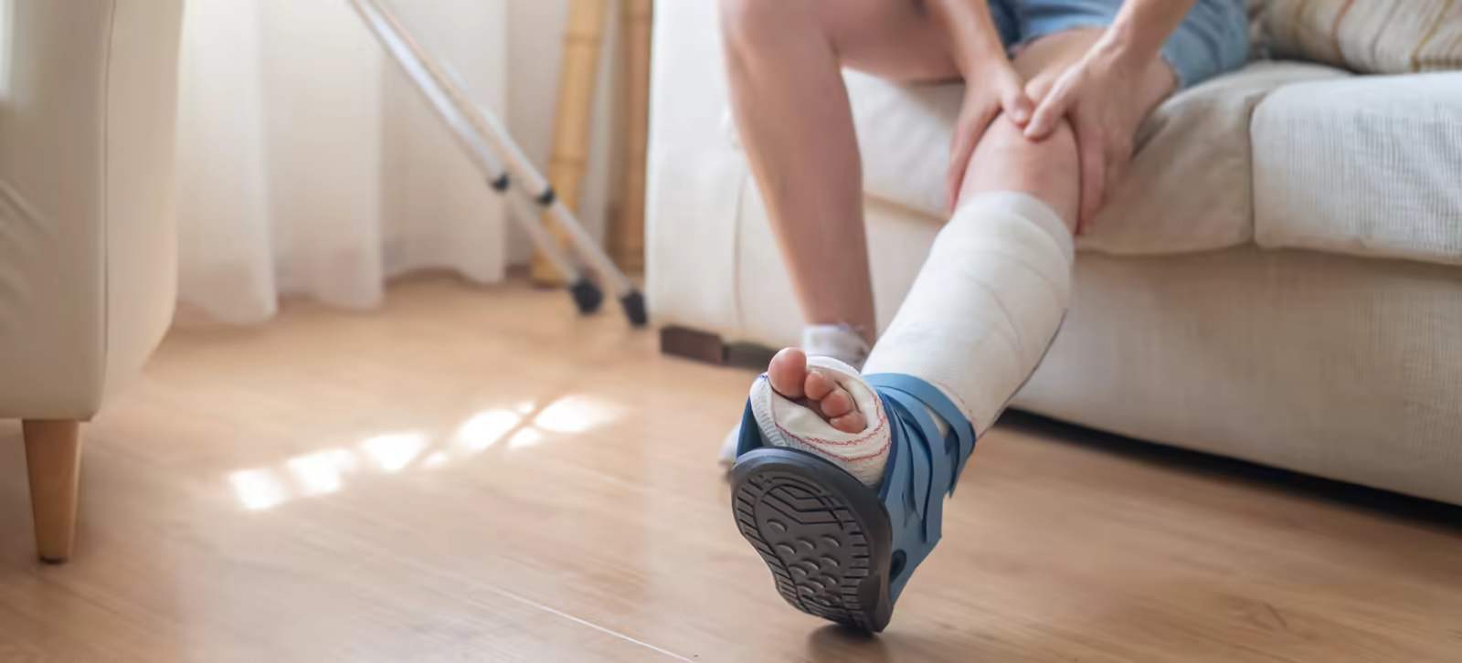 Person recovering with a cast and orthopedic walking boot