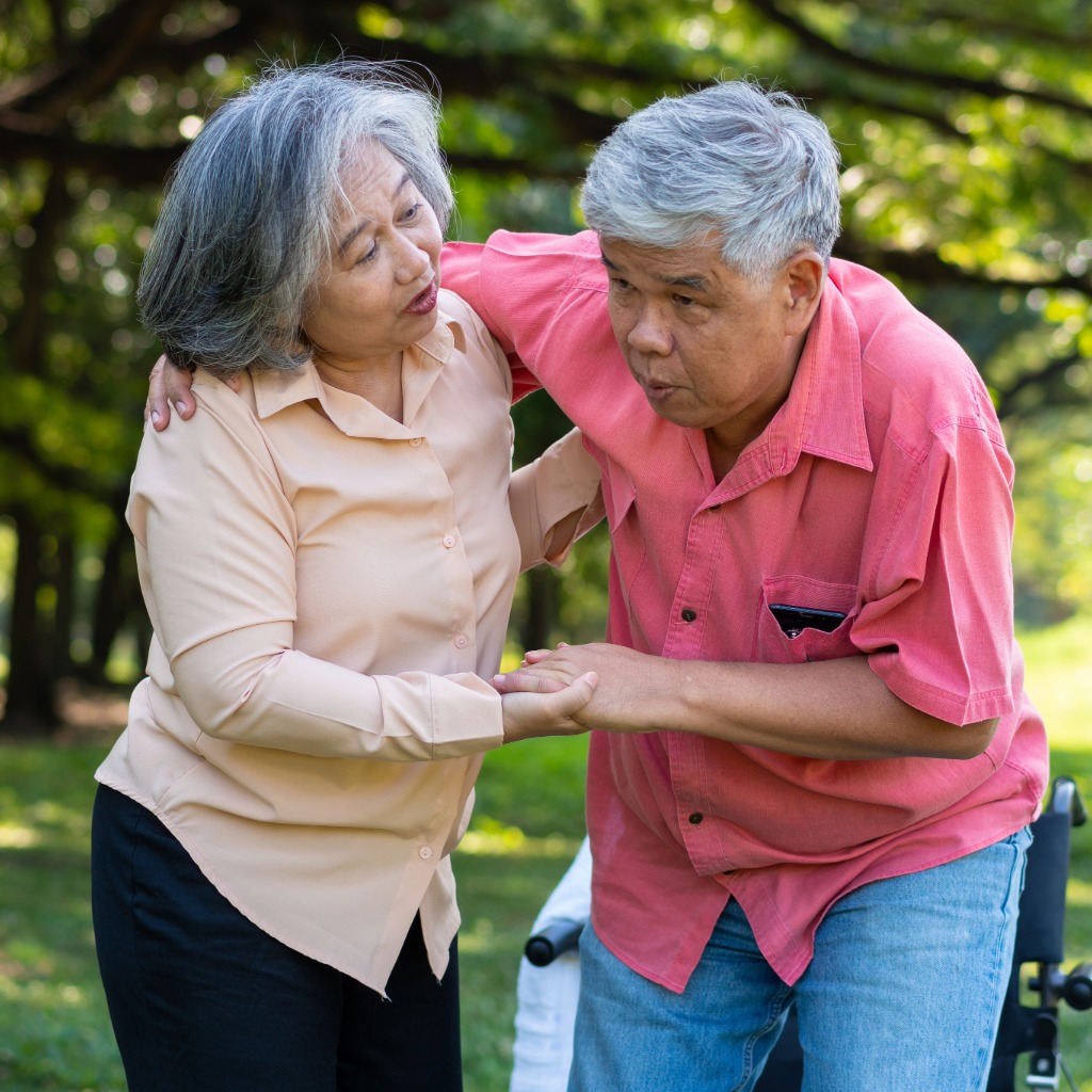 Older adult being assisted after a fall injury