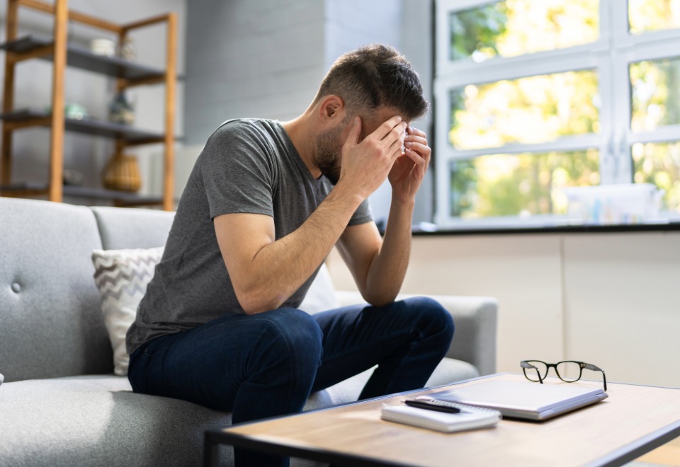 Man dealing with headache symptoms after a brain injury