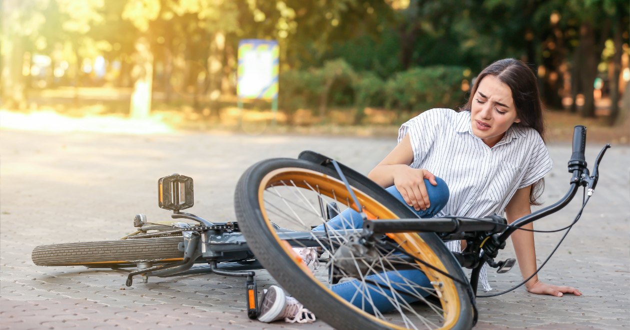 Fallen cyclist and bicycle after a roadway crash