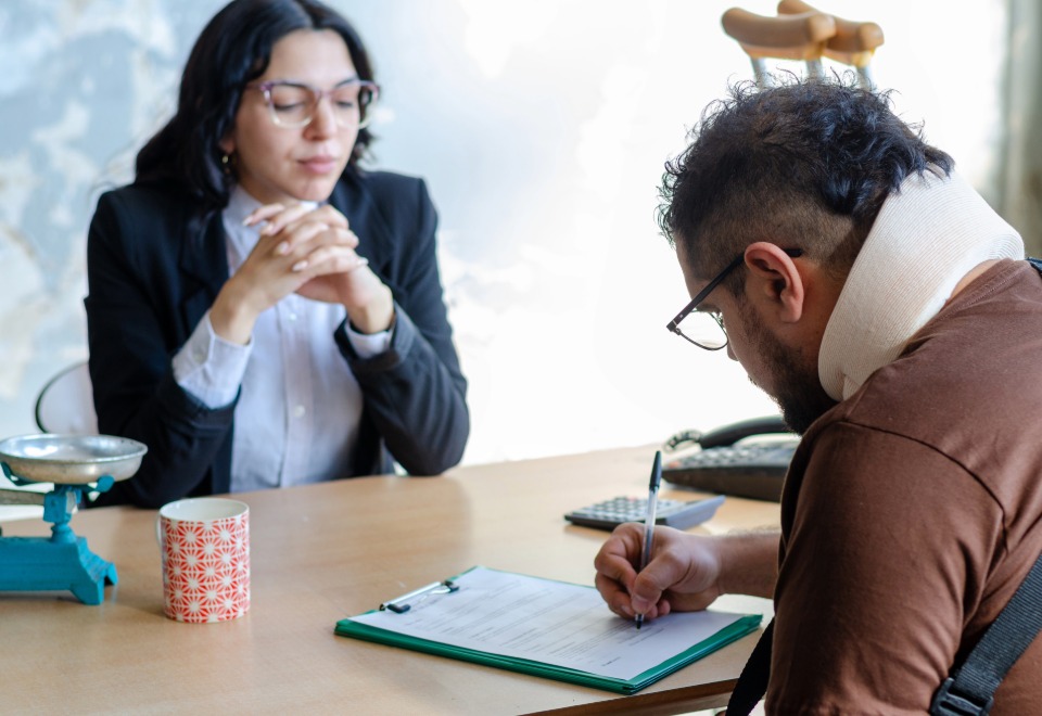Injured car accident client meeting with a lawyer