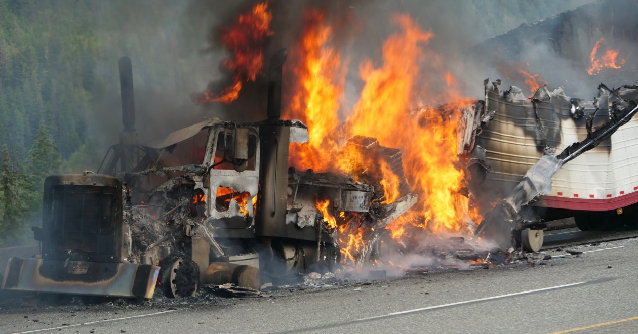 Burning commercial truck at a crash scene