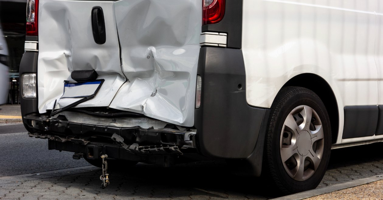 White cargo van side-impact damage