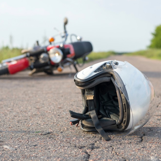 Motorcycle helmet on the road after a crash