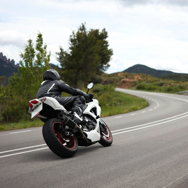 Sport motorcyclist riding a curved road