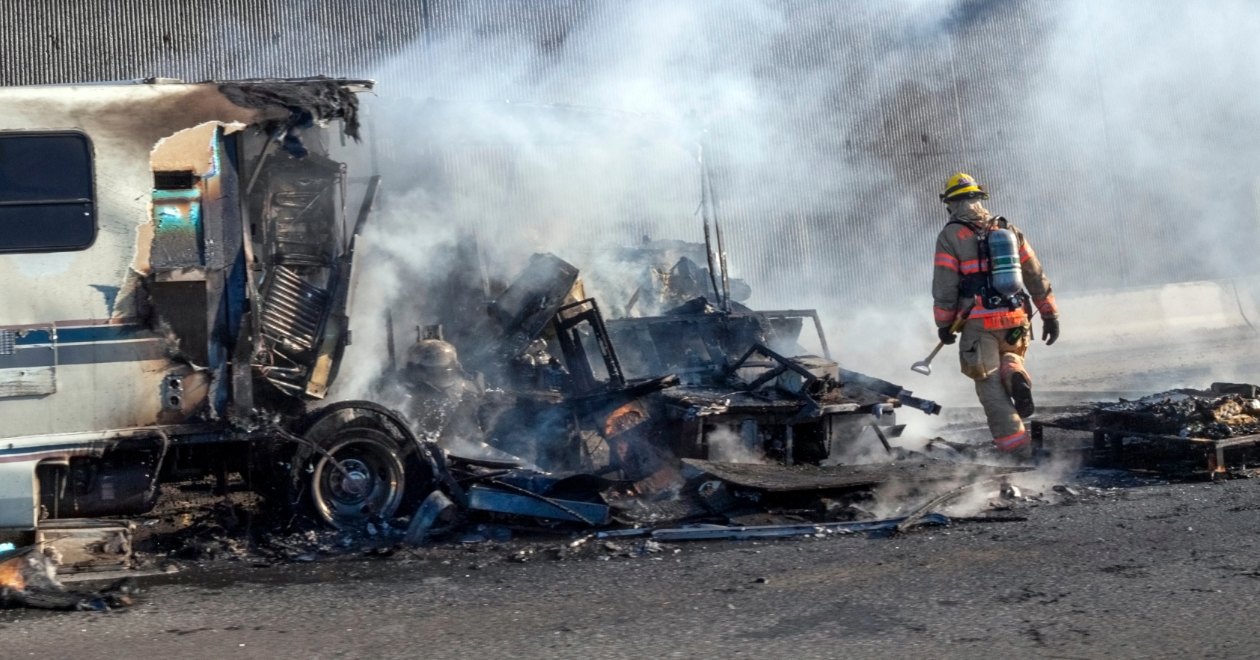 Firefighter at an RV fire crash scene
