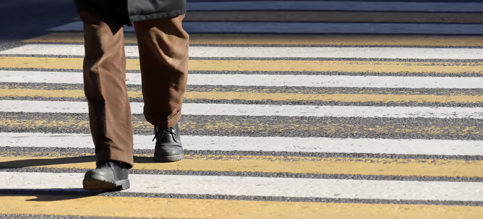 Pedestrian walking across a marked crosswalk