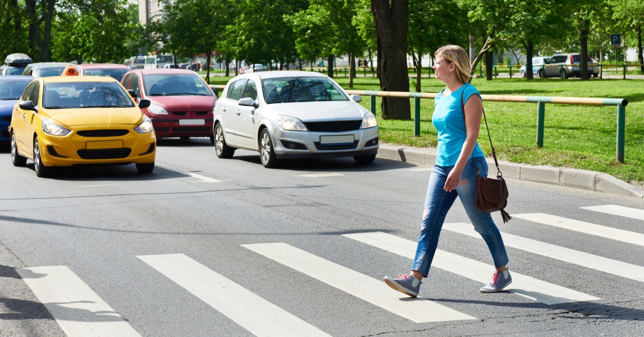 Woman crossing a road with traffic