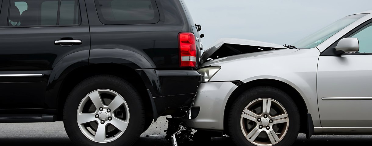 Rear-end collision impact between an SUV and a silver car